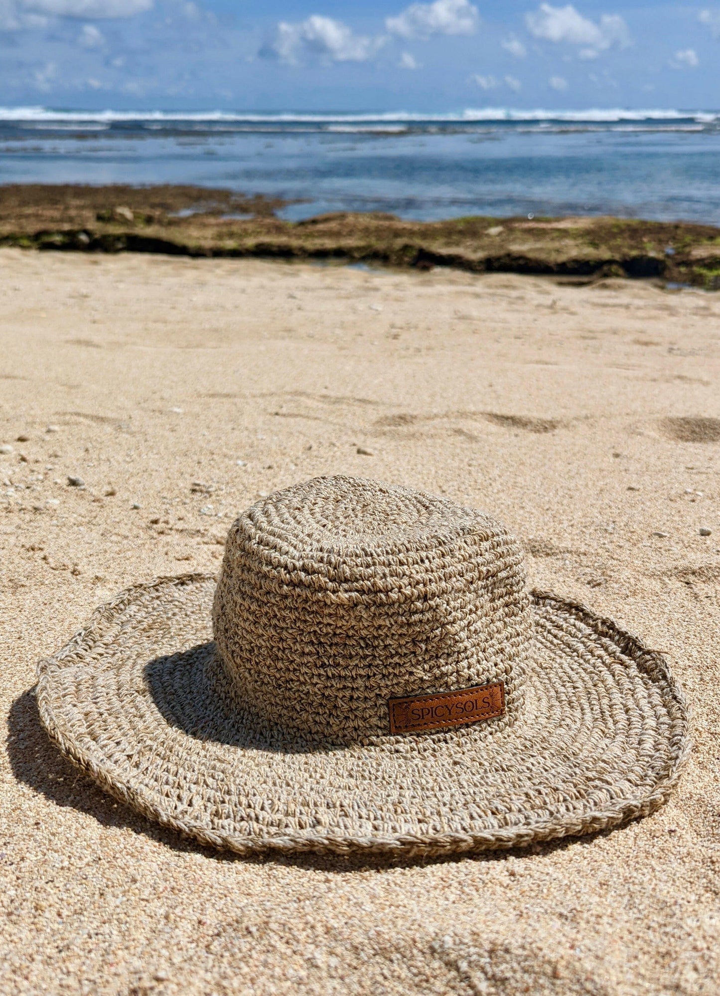 Sustainable sun hat on sandy beach in Australia